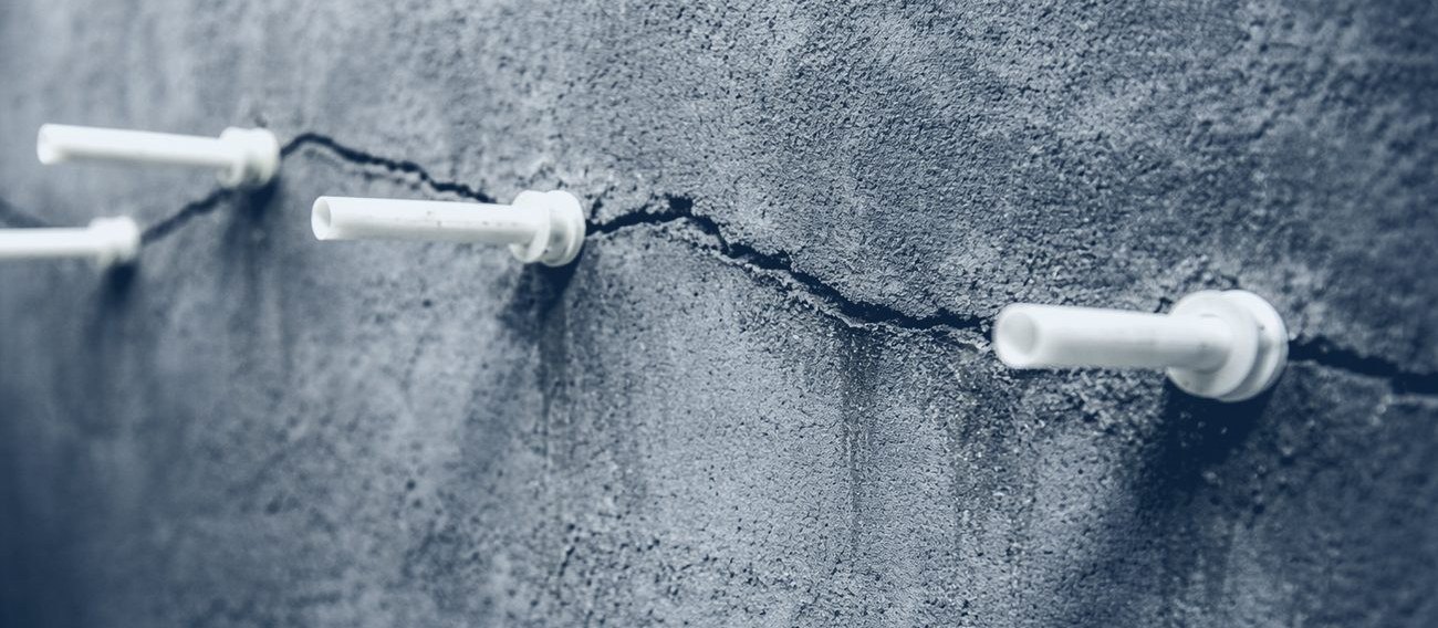 Injection ports installed along a structural crack